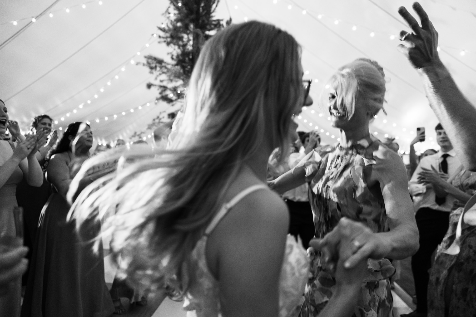 The bride dancing, hair flying, in black and white
