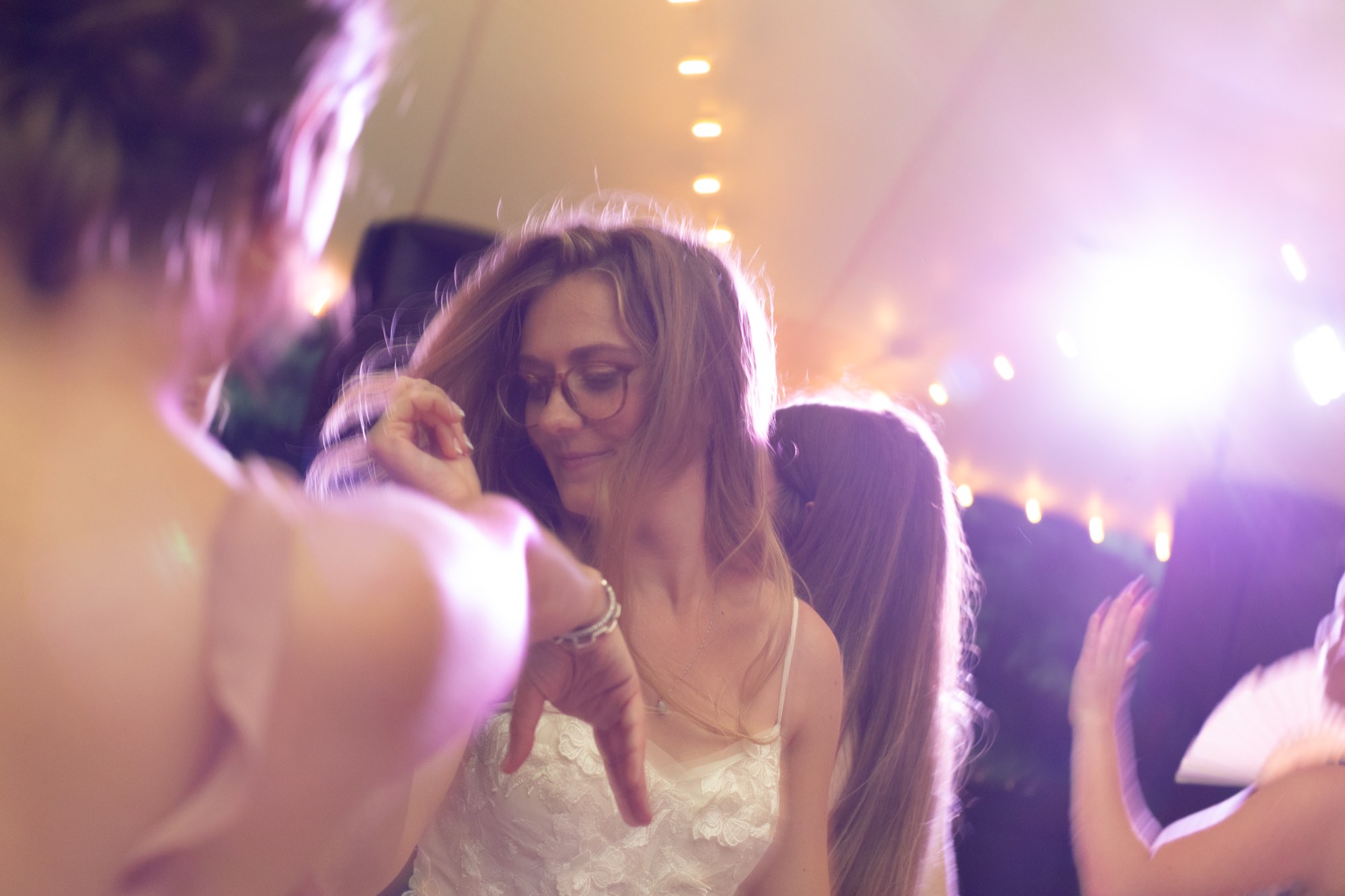 A guest dancing in purple light