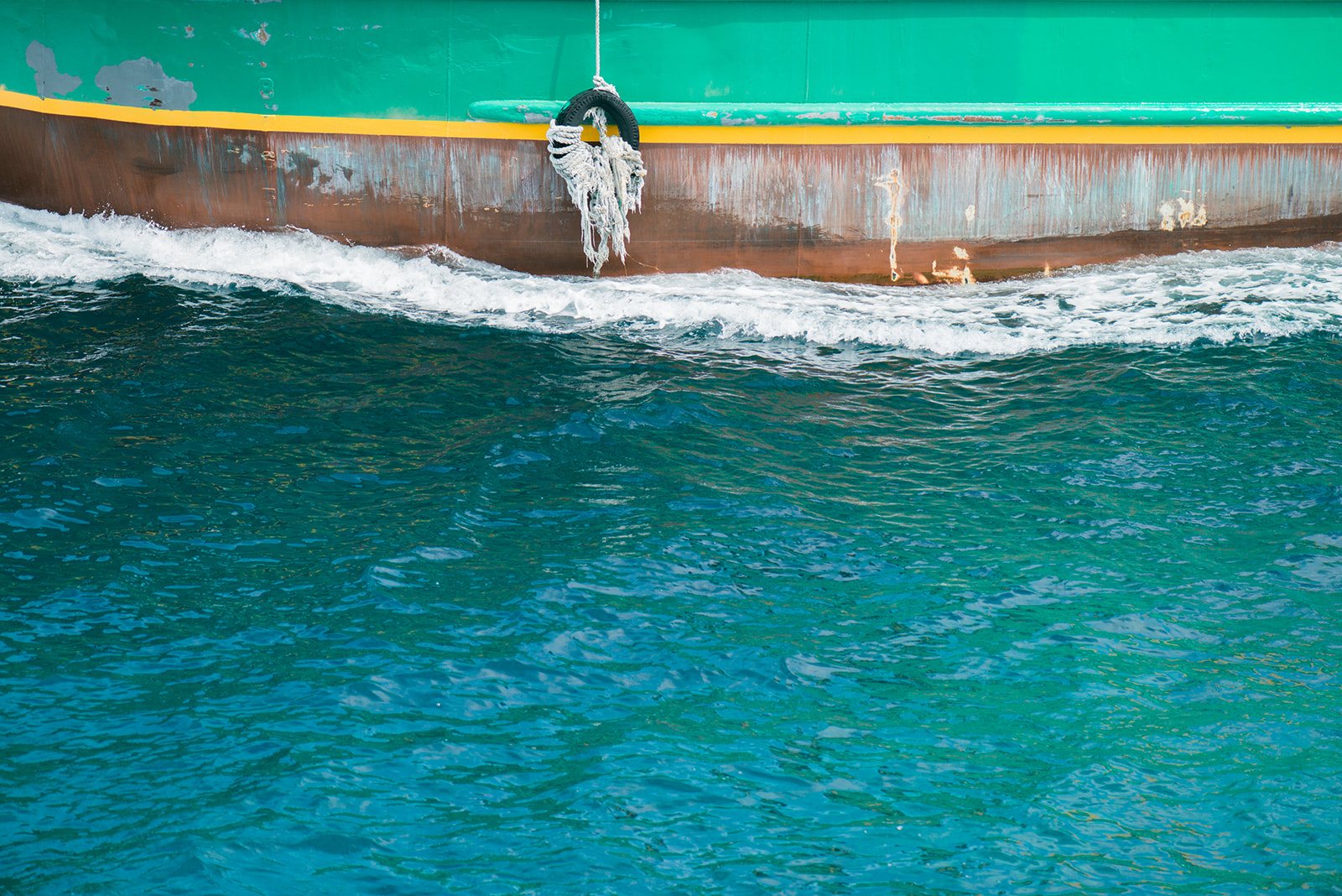 The wake of a boat in turquoise water