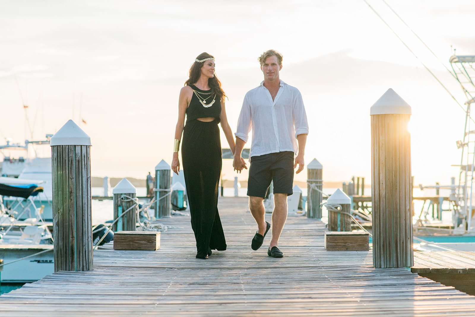 The couple walking the dock at sunset
