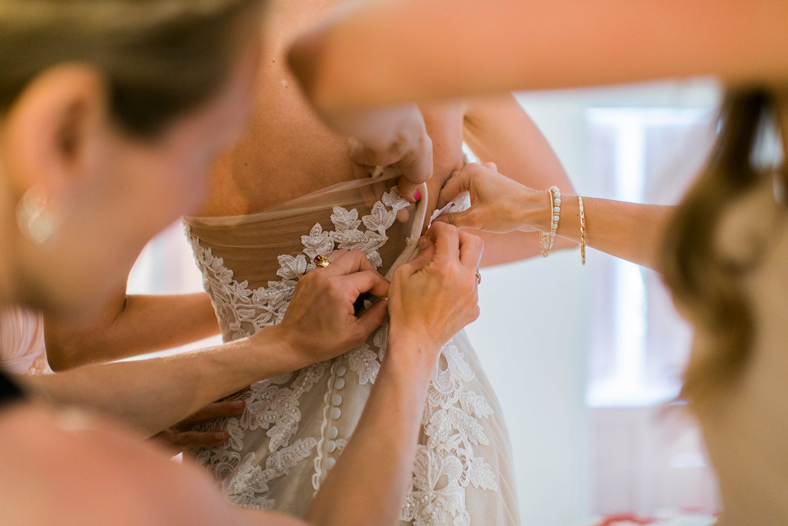 Buttoning the lace gown
