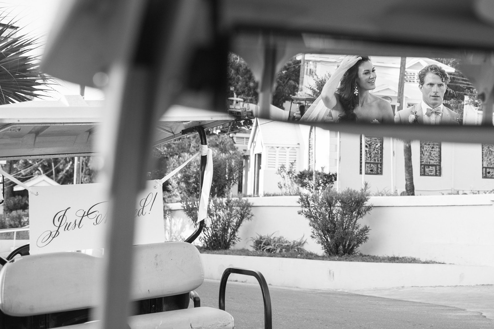 The couple in a golf cart, in black and white