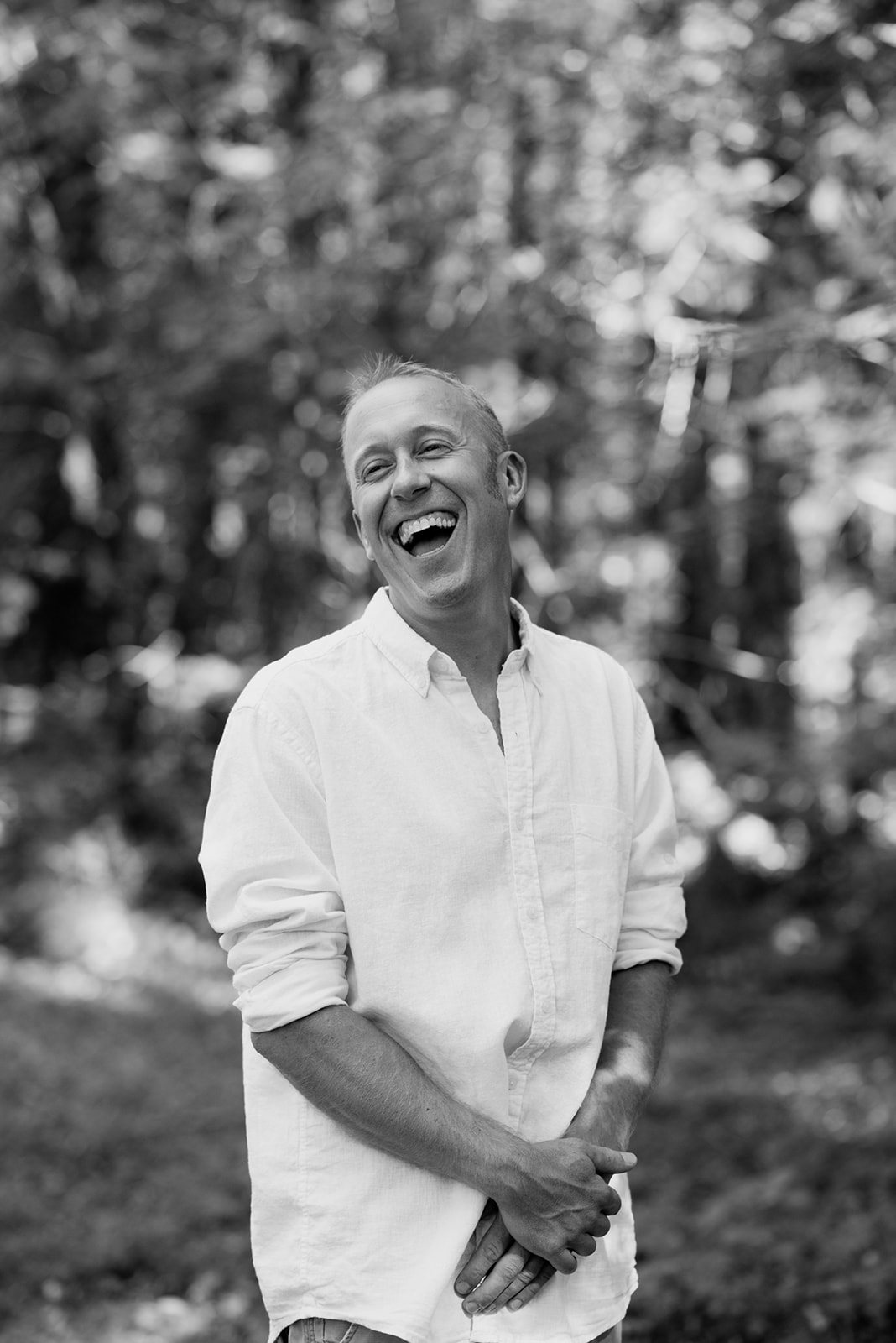 The groom laughing, in black and white