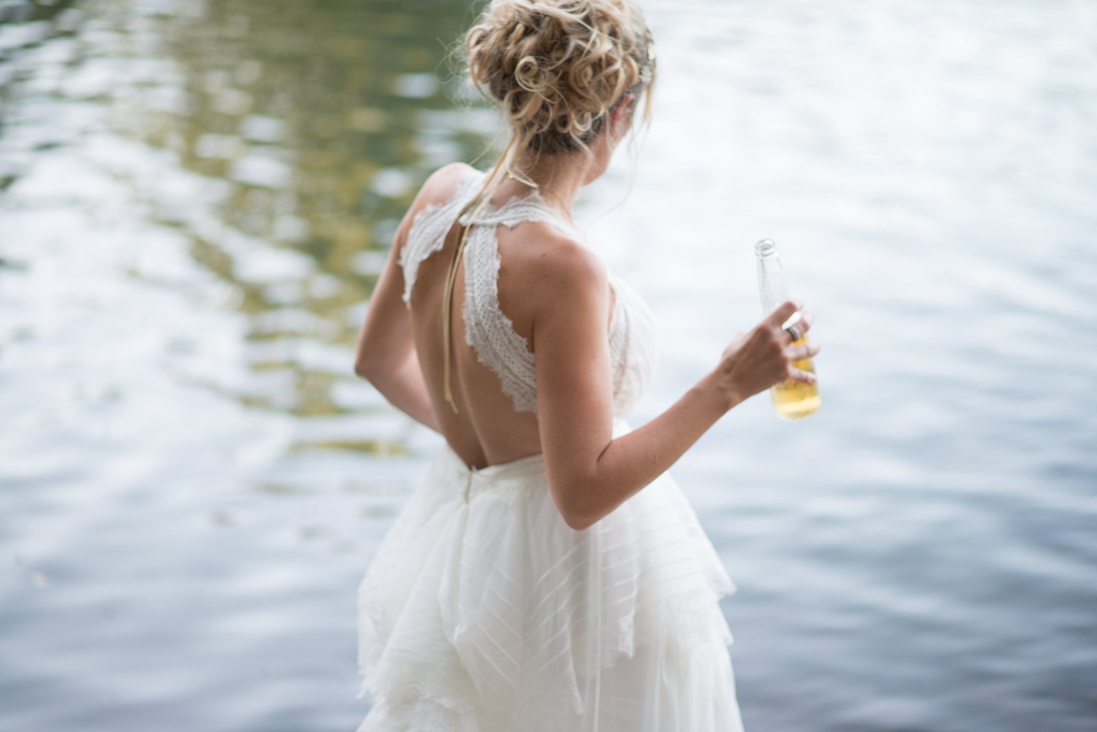 The bride in the lake with a drink