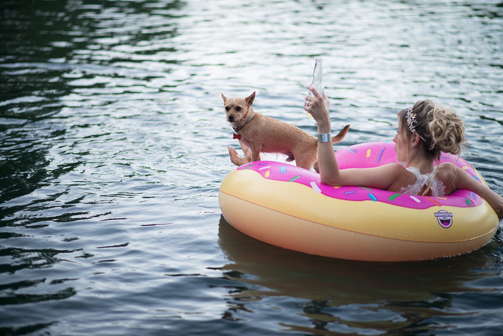 The bride and a dog afloat on the lake