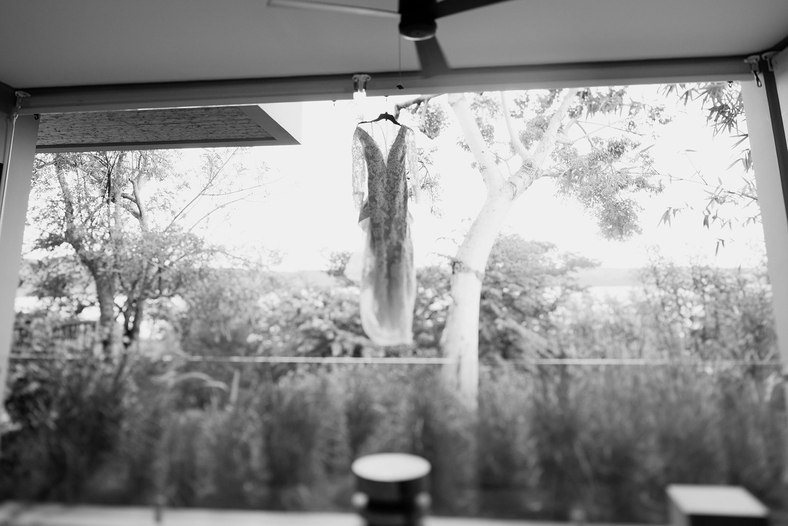 The gown hanging in the window, in black and white