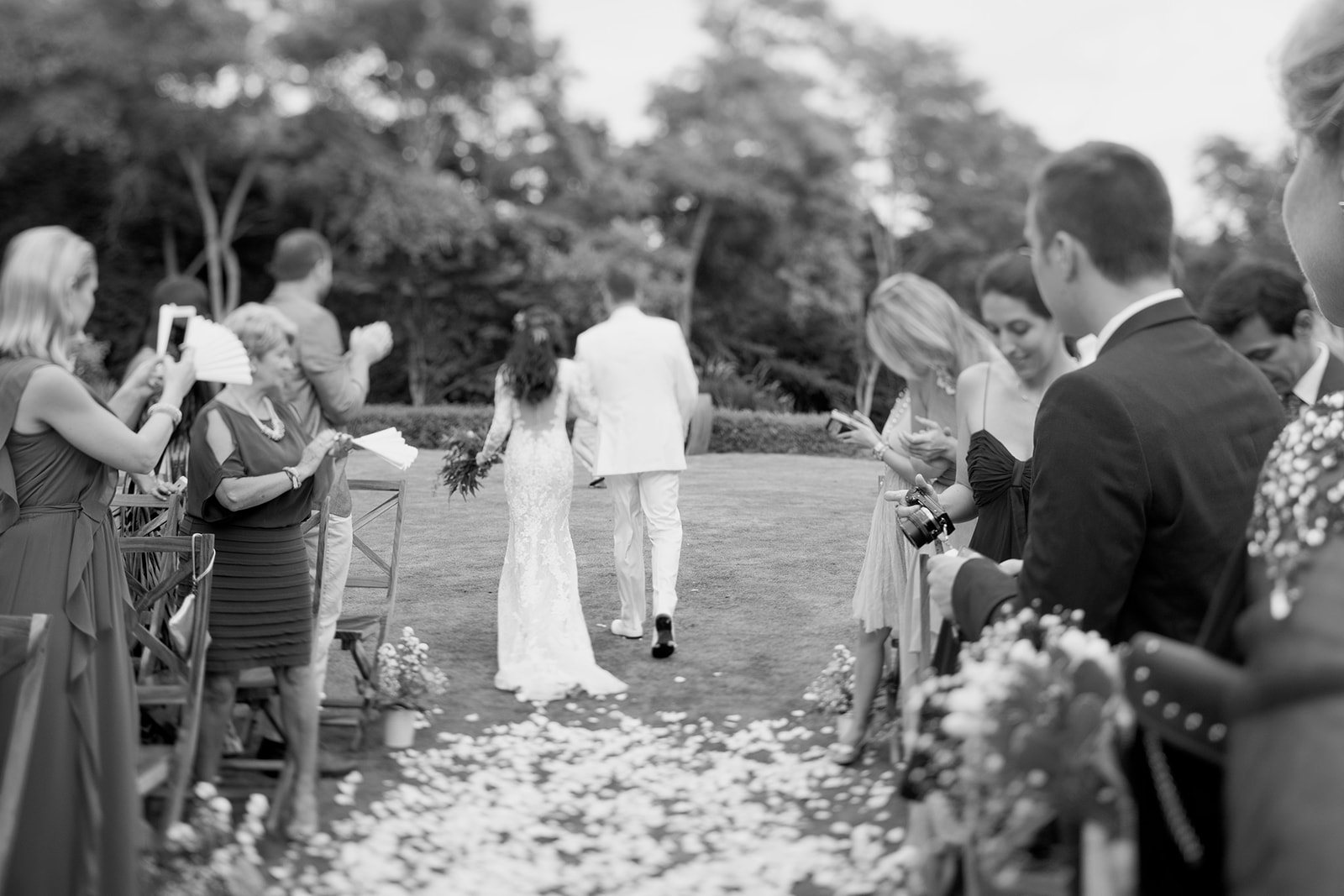 The bride walking up the aisle, in black and white