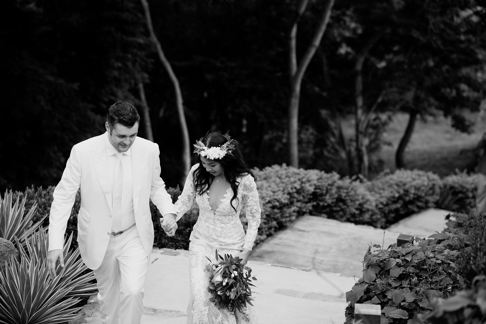 A couple walking down stone steps, in black and white