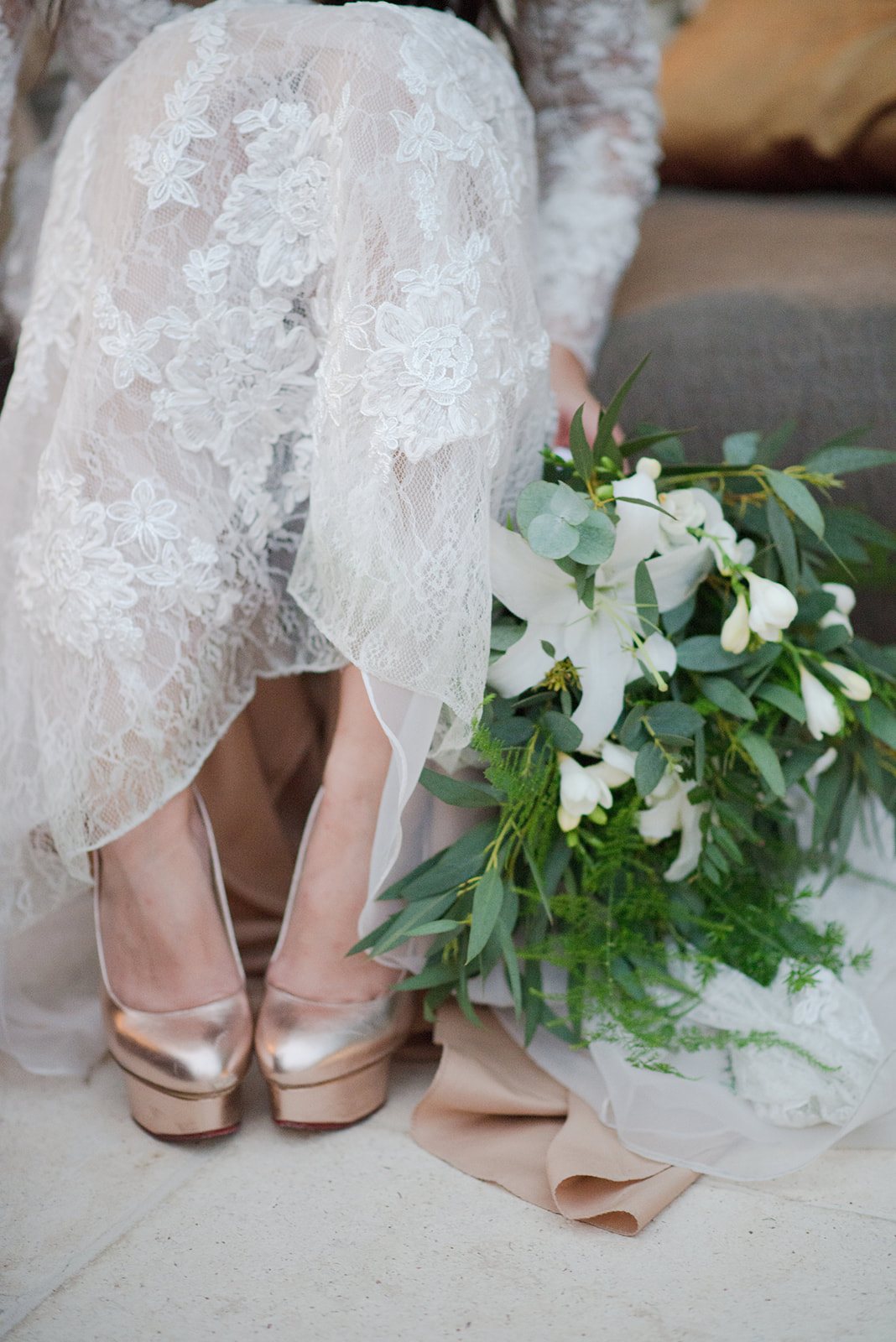 White shoes and a bouquet of lilies