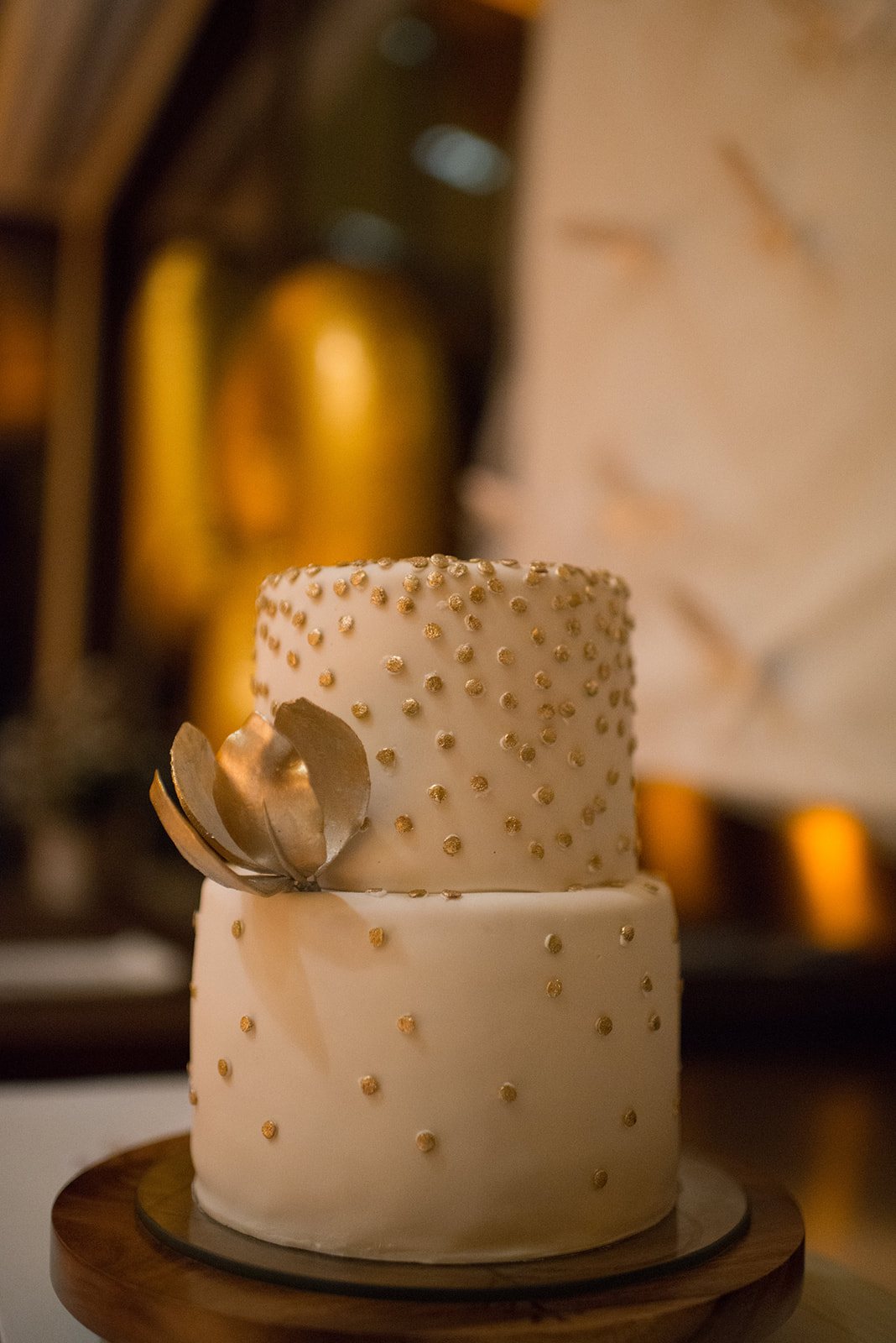 A white wedding cake on a wooden stand