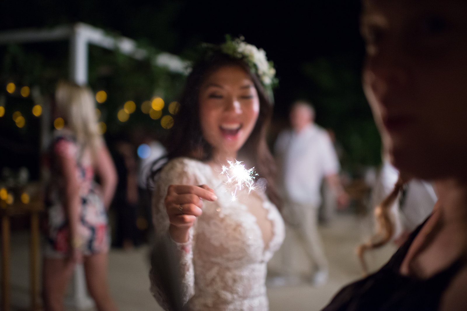 The bride laughing with a sparkler