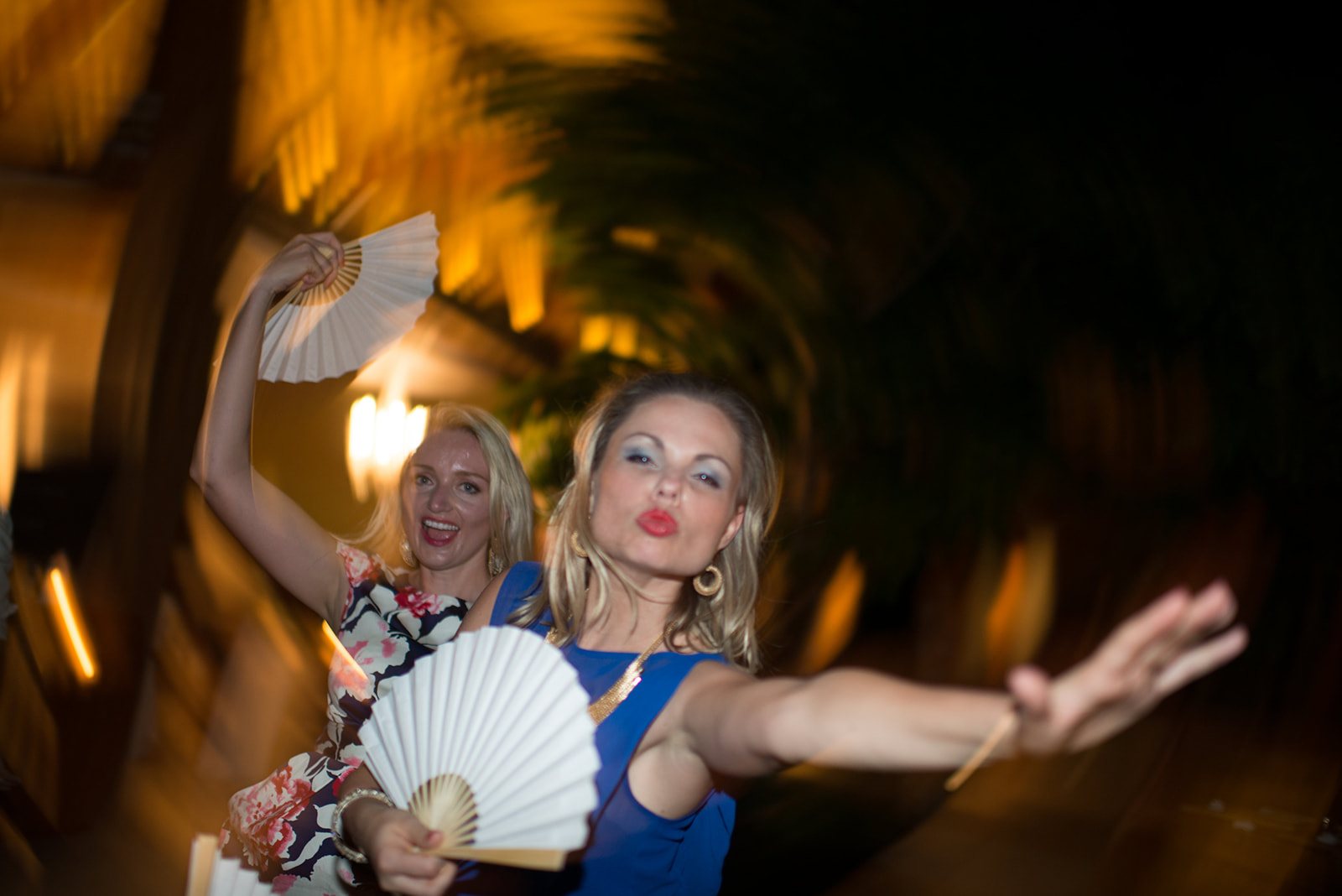 A guest with a fan mid-dance