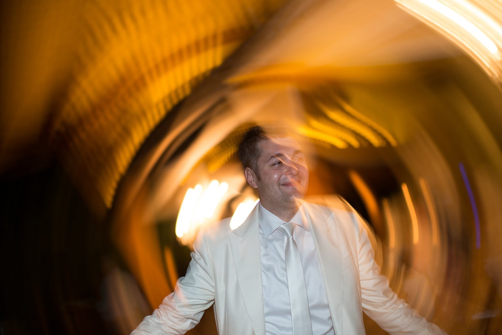 A guest spinning in a blur of gold light
