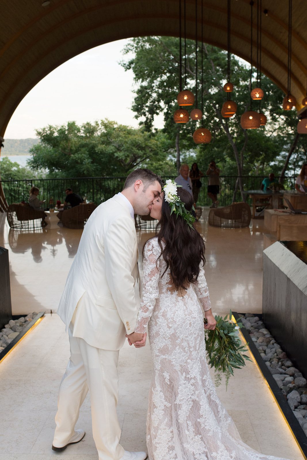 Nancy and Anton kissing under the curved wood archway at the Andaz