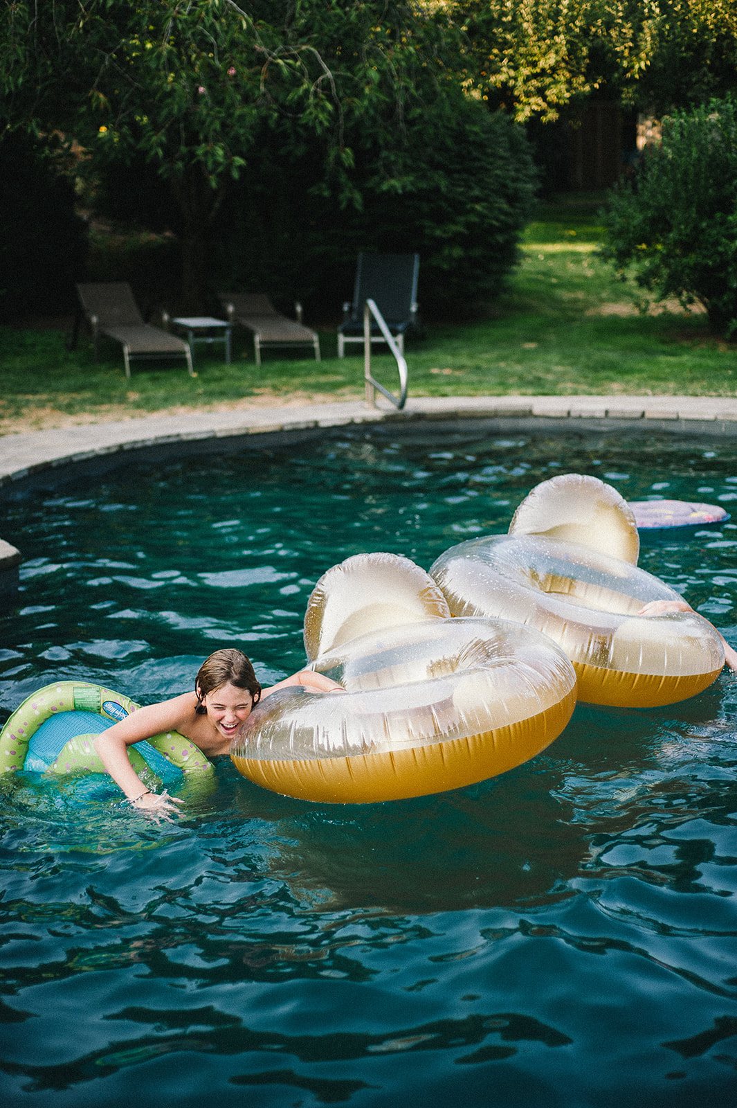 A child on a pool float the day before the wedding