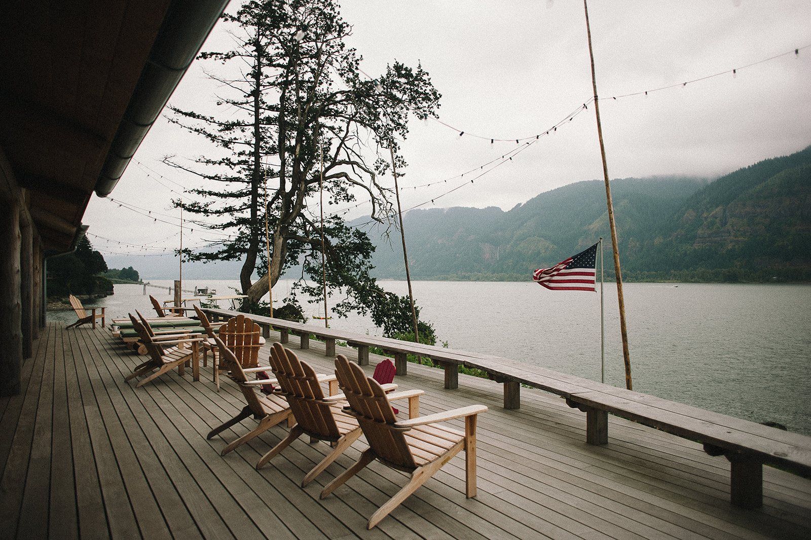 A deck with Adirondack chairs above the Columbia River Gorge