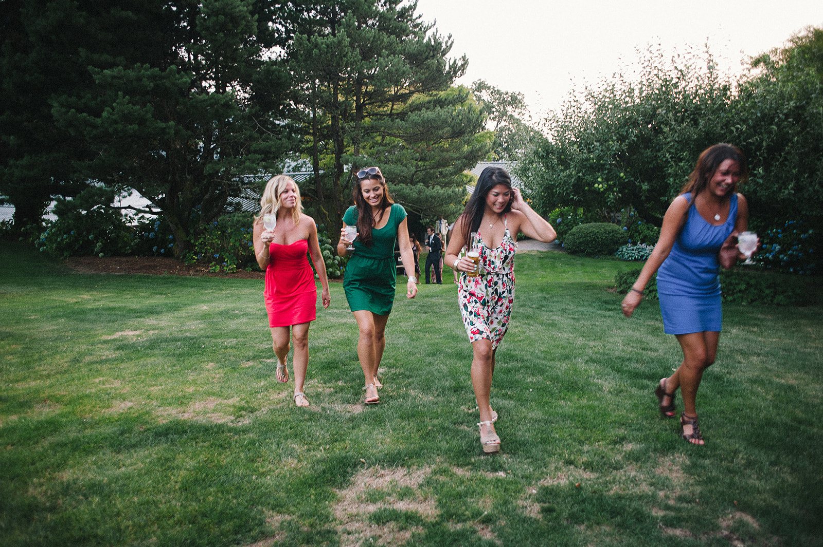 Friends running across the lawn