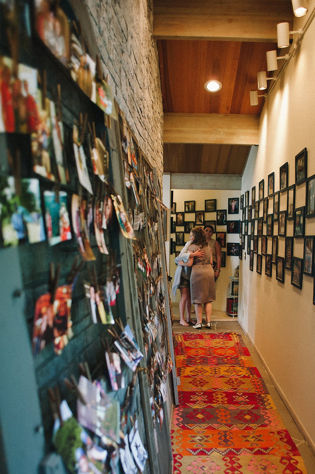 A hallway lined with framed photographs