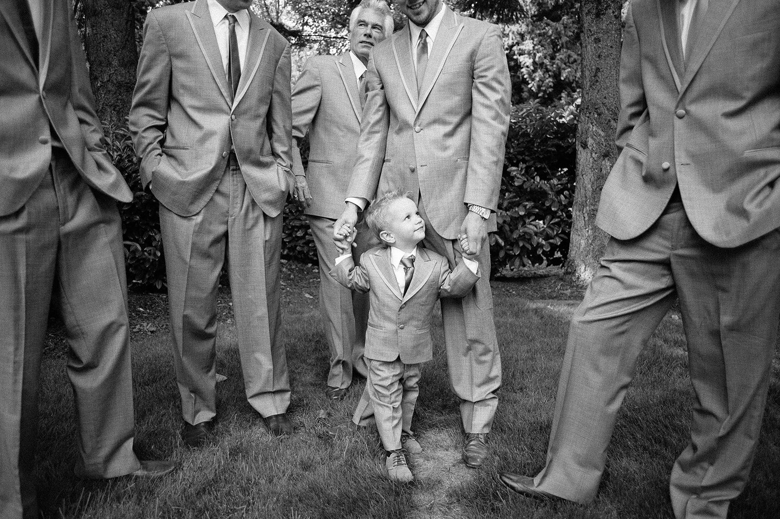 The groomsmen and a small boy, in black and white