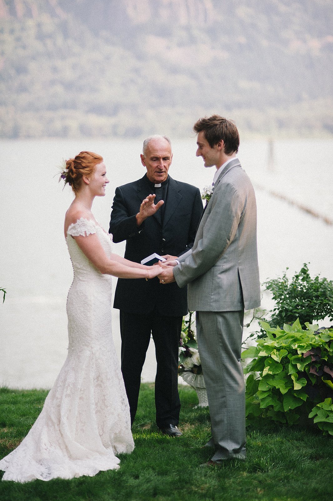 The couple with their officiant during the vows