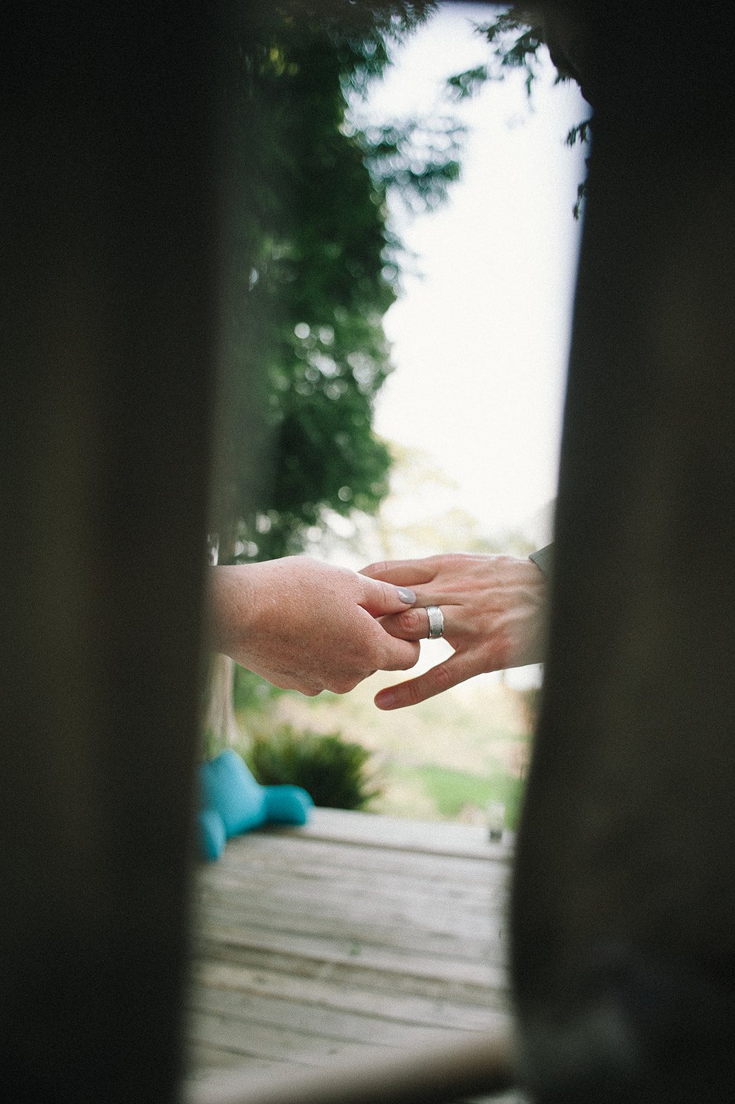 Hands meeting through a doorway