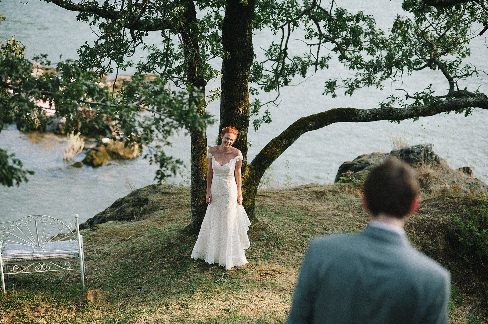 The groom watching the bride under the tree