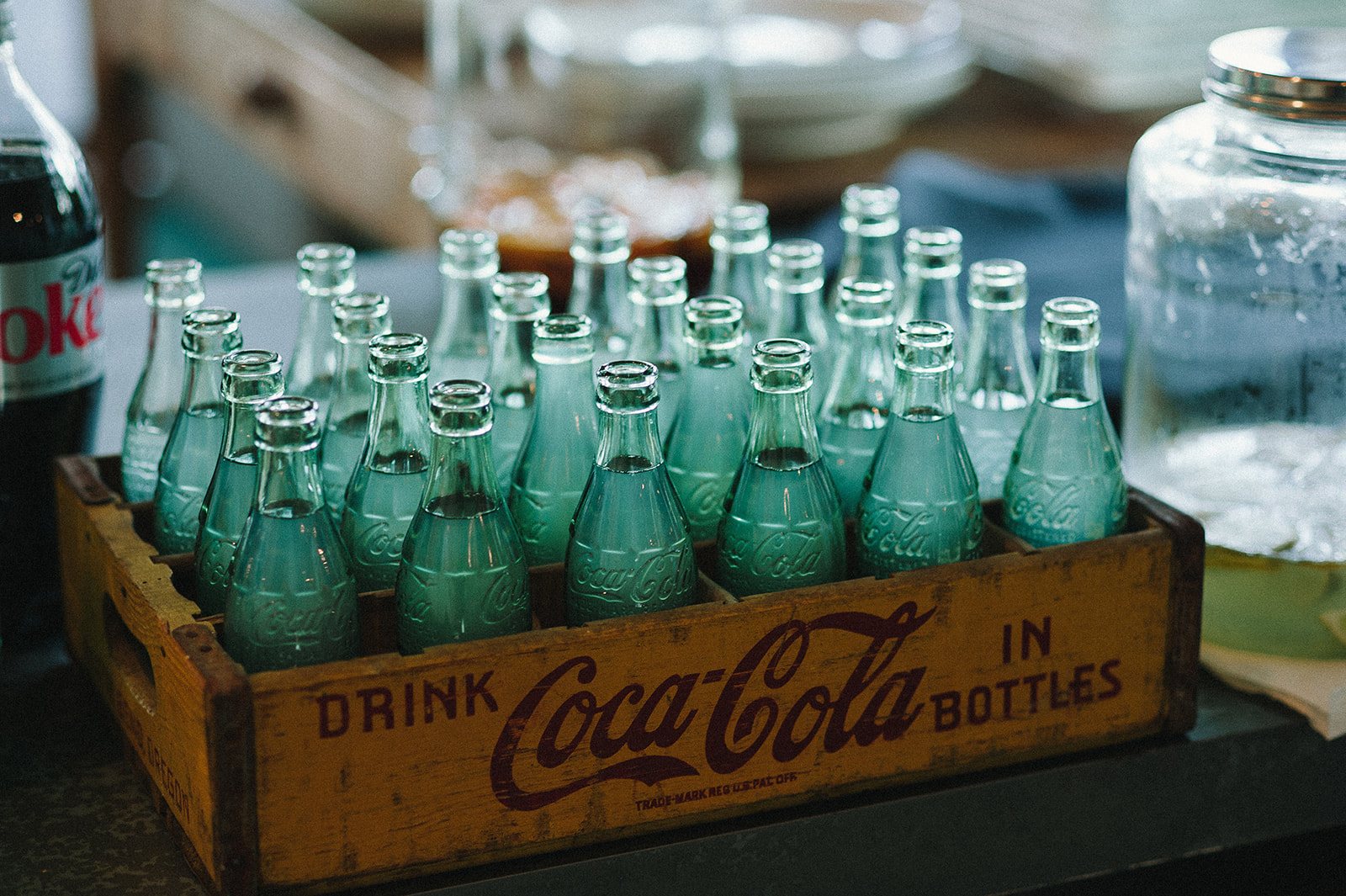 Green glass bottles in a wooden crate