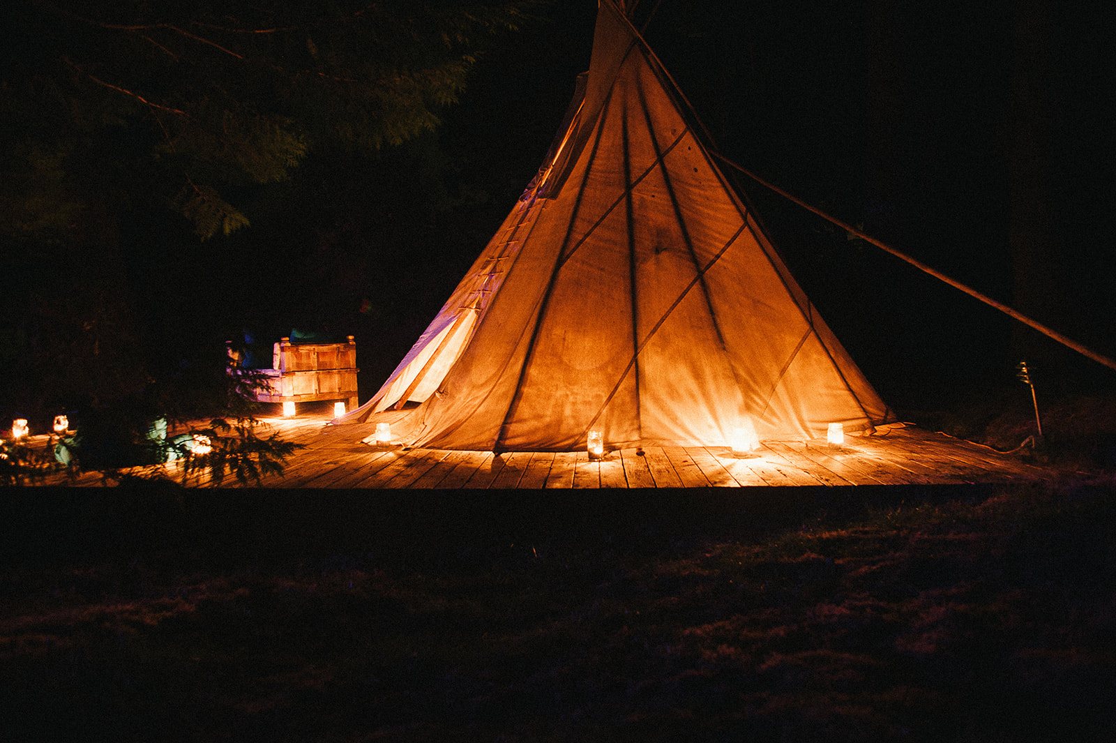 The tipi glowing at night