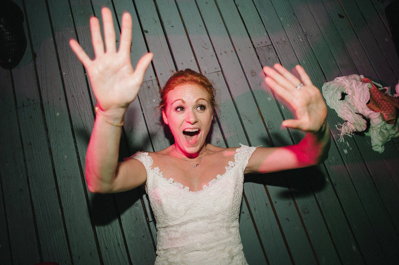 The bride with her hands up, delighted