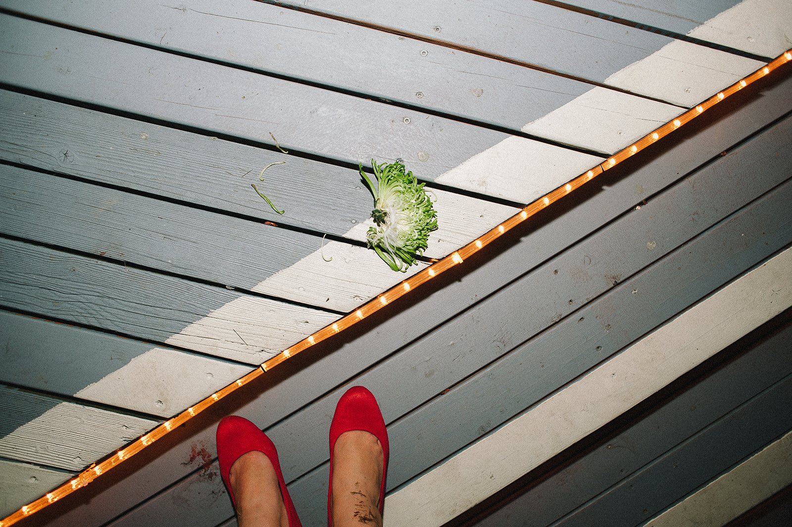 Red shoes on a wooden deck